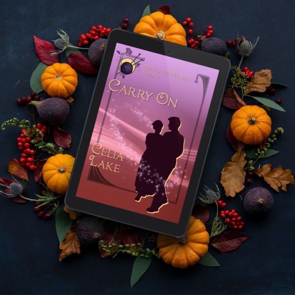 eReader with a copy of Carry On displayed on the cover, sitting on a bed of fall decorations - small pumpkins, bittersweet berries, and dark green leaves