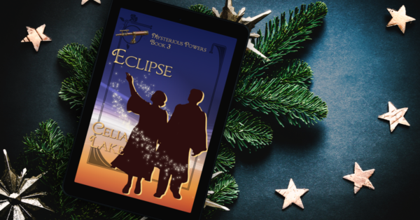 An ereader displaying the cover of Eclipse lies on a bed of pine boughs, surrounded by scattered gold stars. The twilight blue and gold cover shows a silhouetted man and woman, the woman's hand reaching up to point at something in the sky. A small telescope is inset in the top left and the figures are circled by stars. 