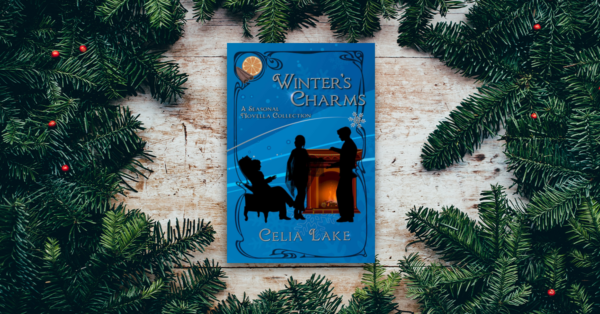 A copy of Winter's Charms, sitting on a wooden table with evergreen boughs and red berries surrounding it. The cover has three people (two standing, one sitting) around a hearthfire with seasonal decorations.