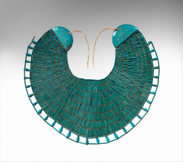 A broad collar made of intricately placed faience beads forming rays out from the centre, with a layer of spaced beads on the outer edge, threaded on fine silk thread. 