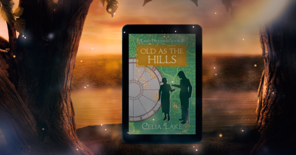 The cover of Old As The Hills displayed on a tablet in a scene of a glowing golden summer sunset, looking out over a pond surrounded by tree trunks. The cover of Old As The Hills has a man with a can and a woman silhouetted on a green ground with a map. She holds out her hand, he is putting something into it, forming a doorway between them. An astrological chart behind them shows the symbols for Venus, the Sun, Jupiter, and Saturn highlighted behind a splash of glowing stars.