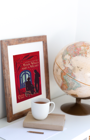 The cover of Four Walls and a Heart in a frame, with a globe and cup of coffee. The cover is a deep red, with a man in a wheelchair and a man standing, both in silhouette, in front of a large blue and glass door. 